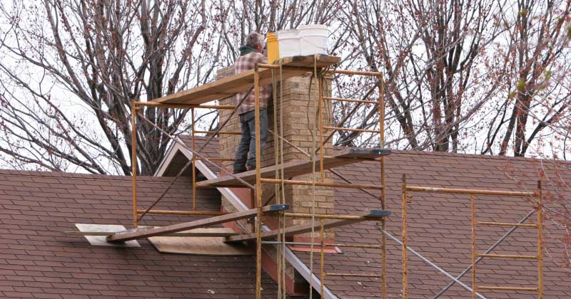 Partial chimney rebuild above the roofline on a Syracuse NY home. A-Z Construction masonry restoration